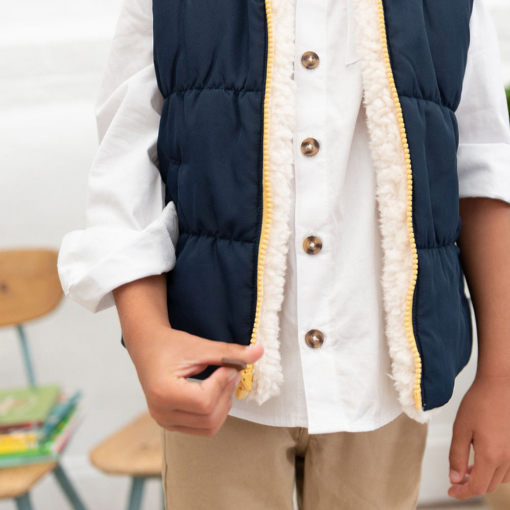 boy wearing white buttondown with sherpa vest