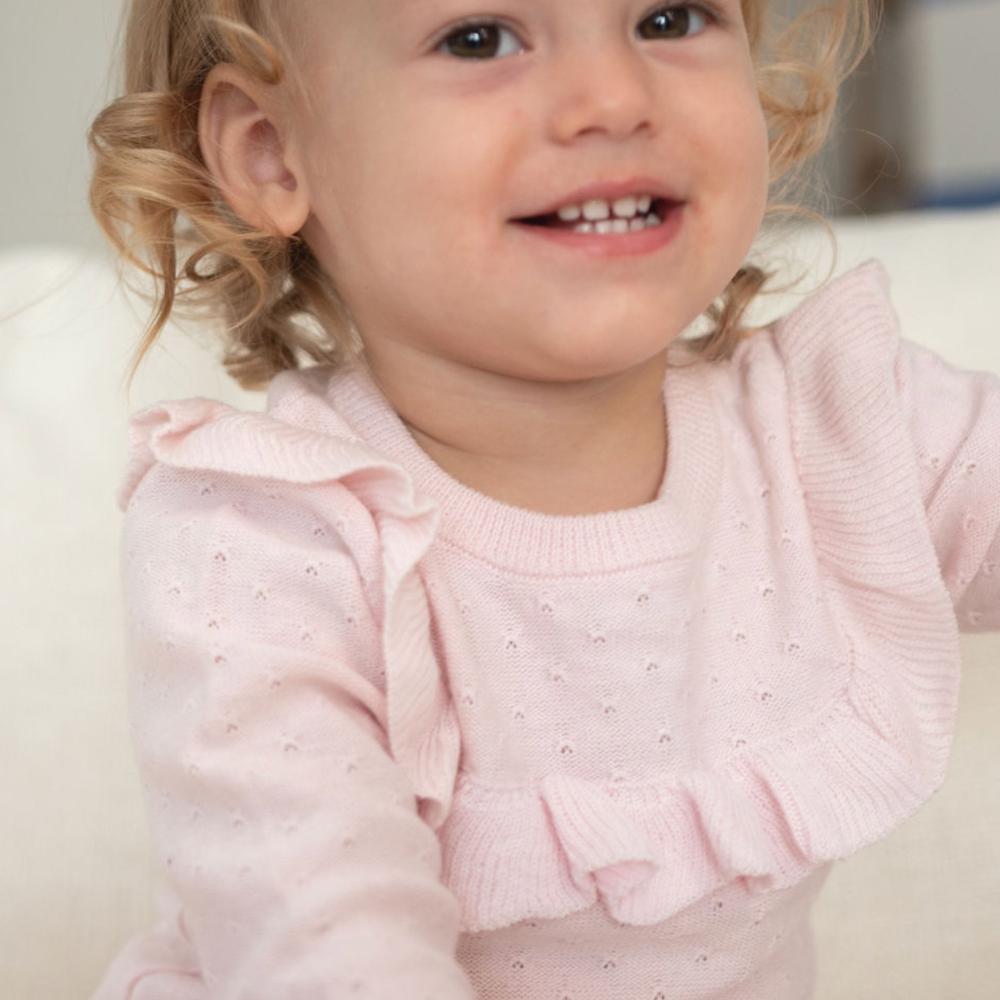 closeup of pink sweater romper