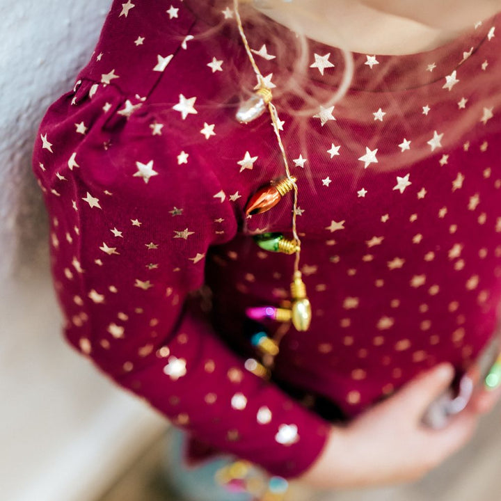 close up picture of girl wearing red shirt with stars