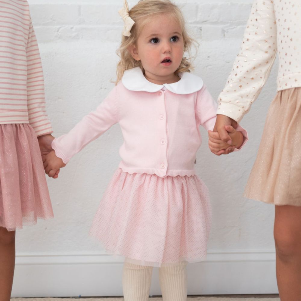 little girl wearing pink tutu and cardigan