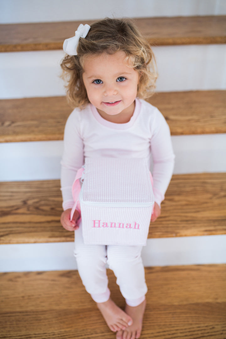 girl on steps with monogram lunchbox