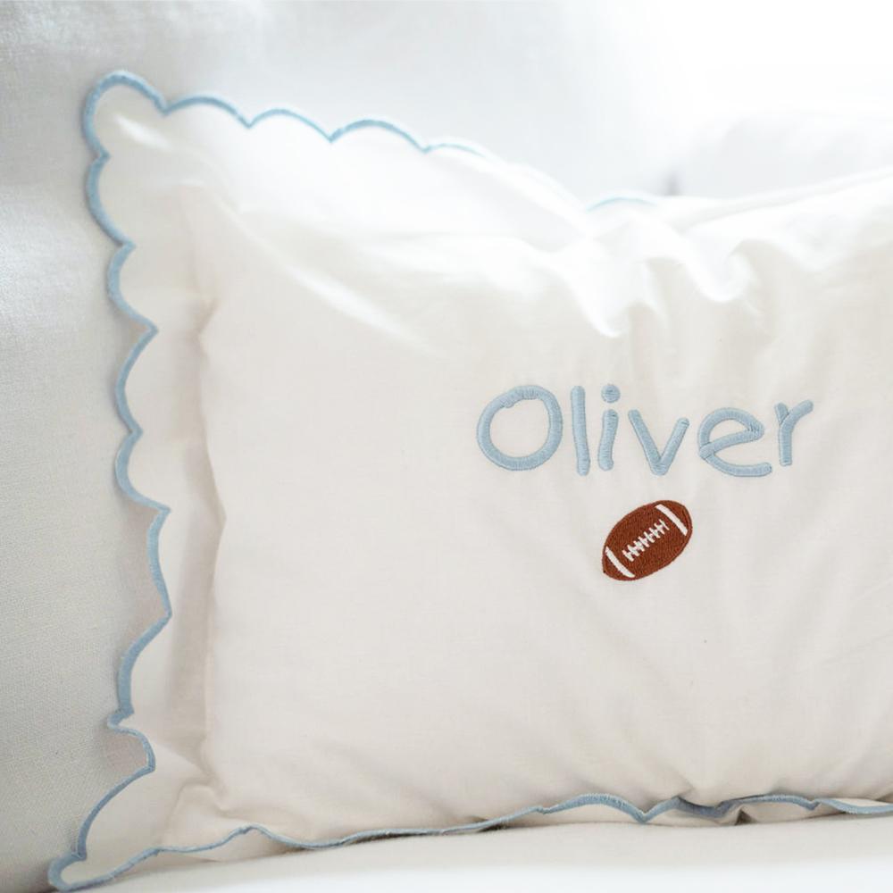 White scalloped pillow with monogram