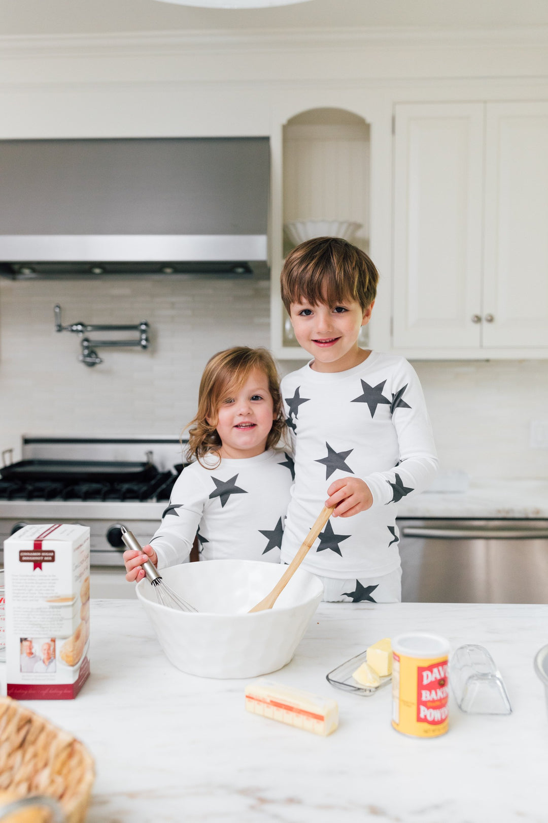 two kids cooking in black star pajamas