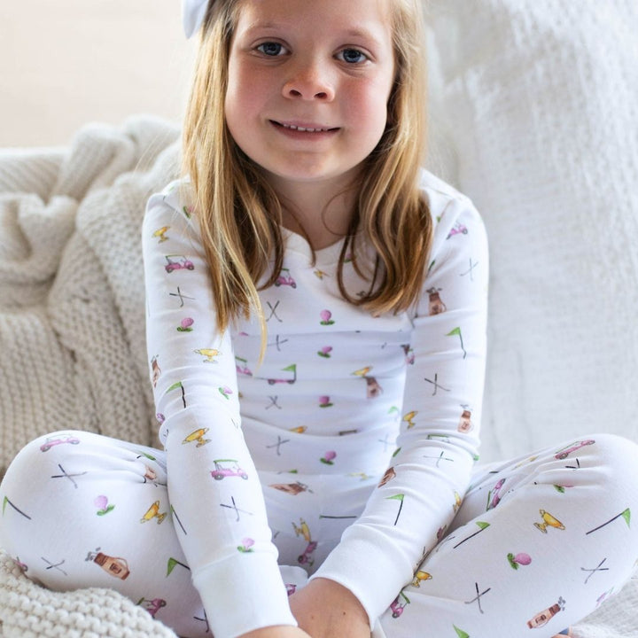 girl wearing pink golf pajamas