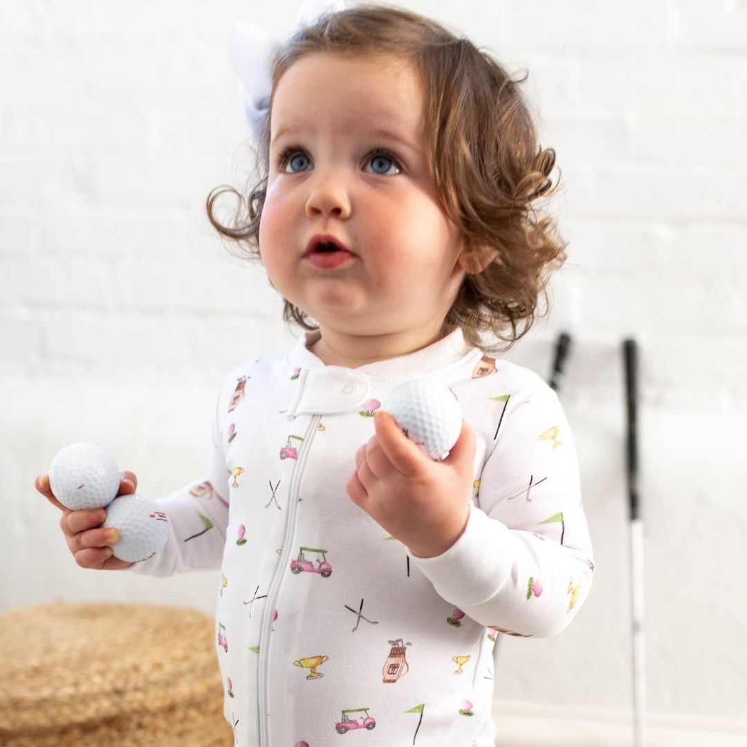 baby girl wearing pink golf print zipper romper