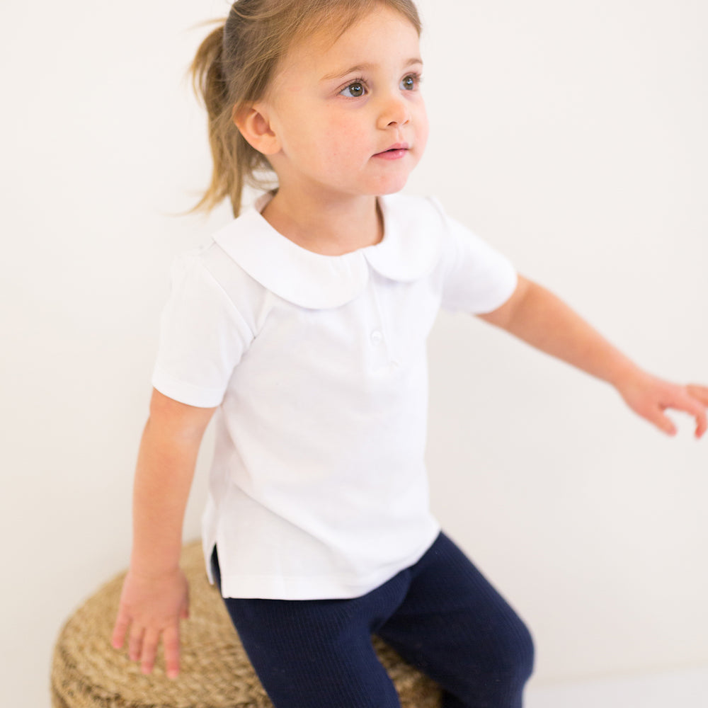 little girl wearing peter pan collar shirt