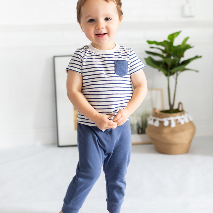 boy wearing striped shirt navy joggers