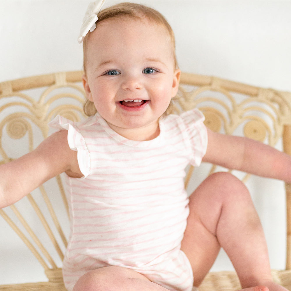 baby wearing pink striped bubble