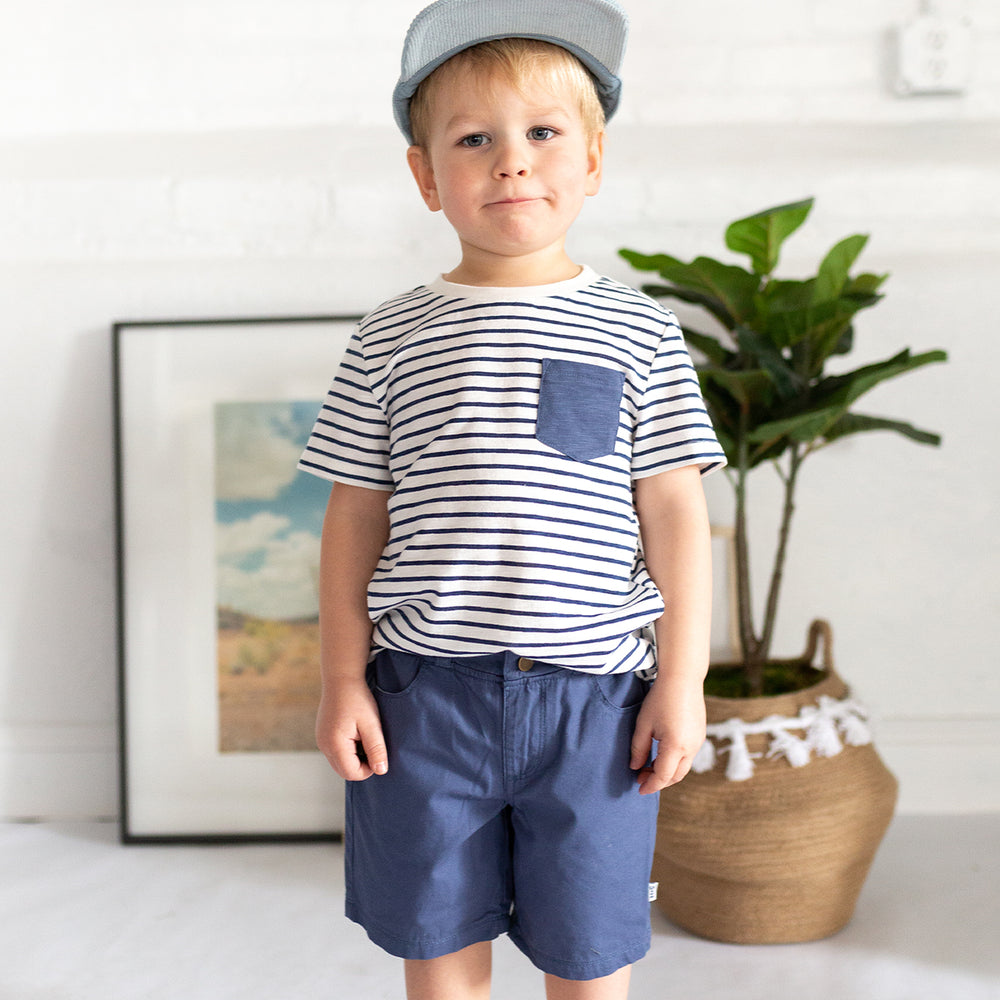 boy wearing striped shirt navy shorts