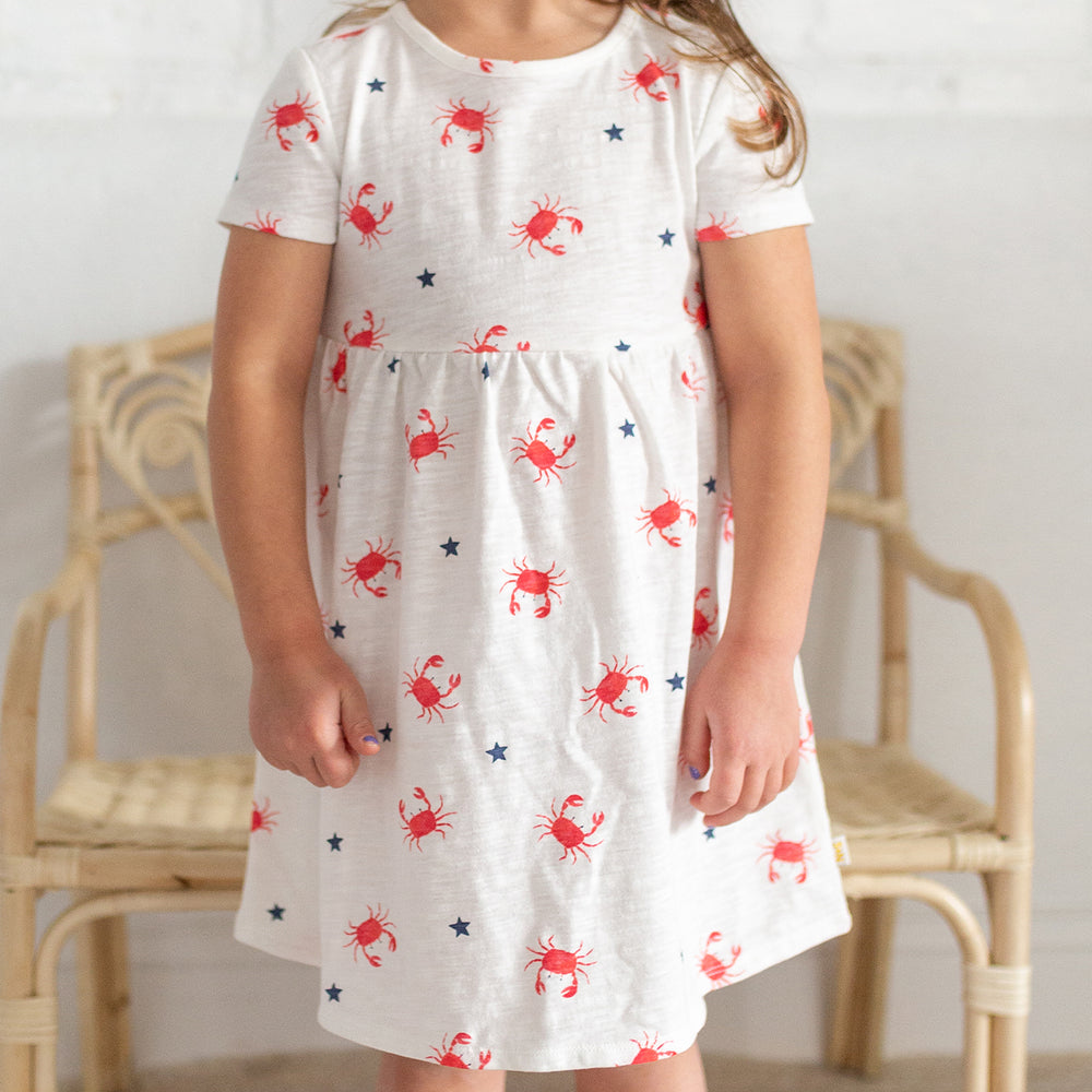 girl wearing crab print dress