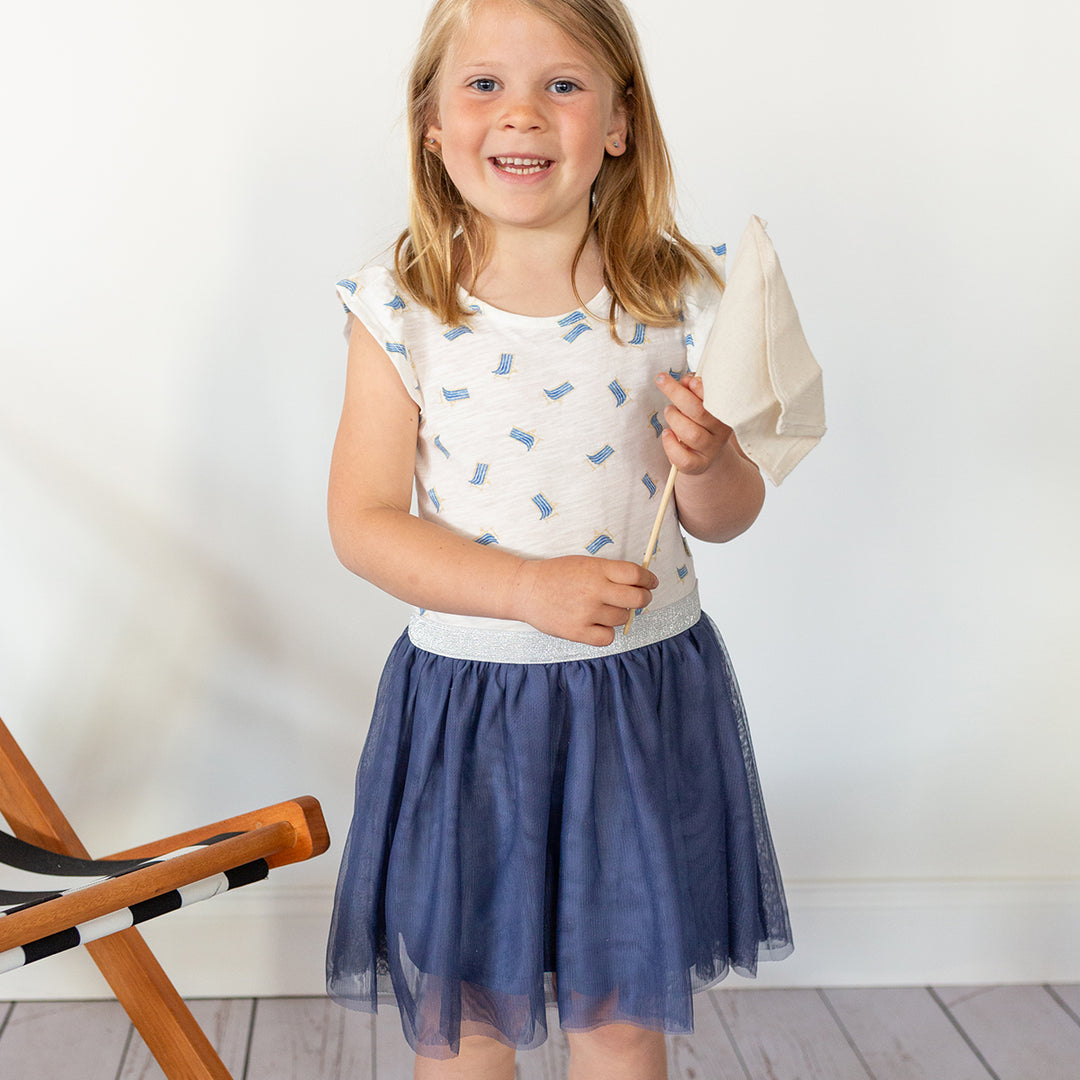 girl wearing beach chair print dress