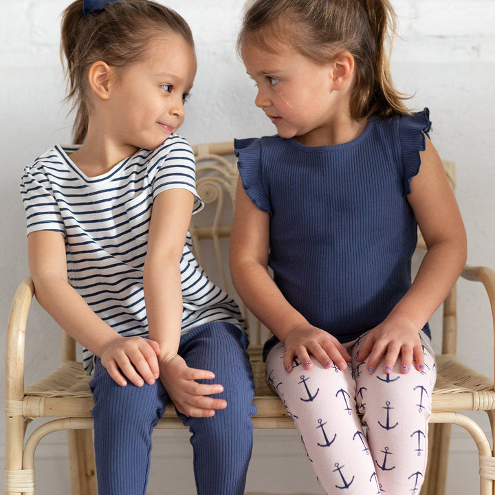 two girls wearing striped shirt and navy tank top