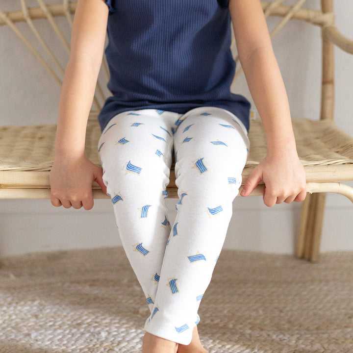 girl sitting on bench wearing beach chair leggings