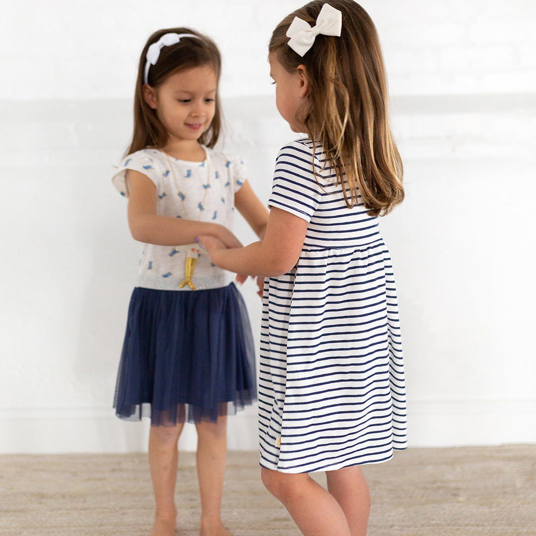 two girls wearing beach chair dress and navy stripe dress