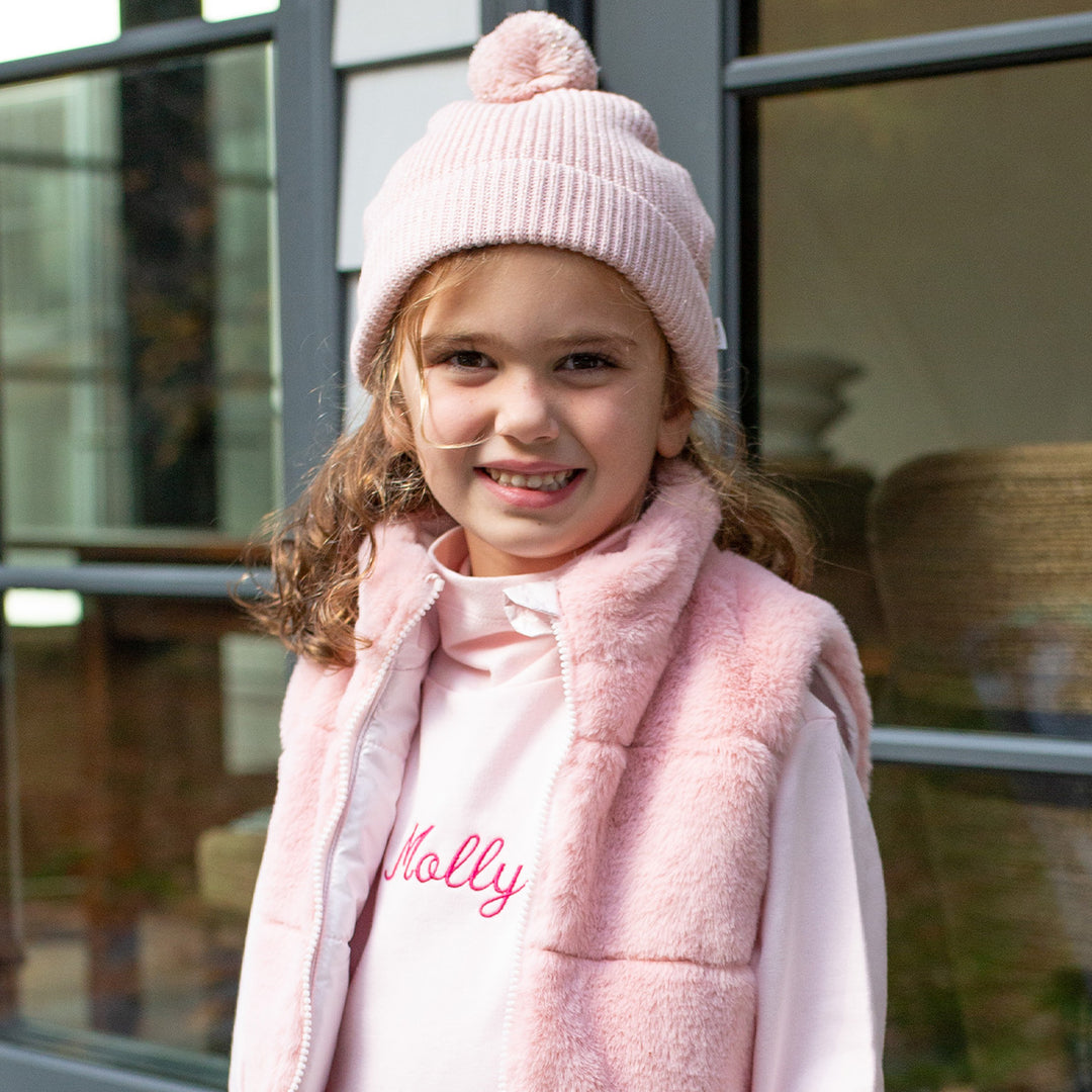 girl wearing winter hat in pink