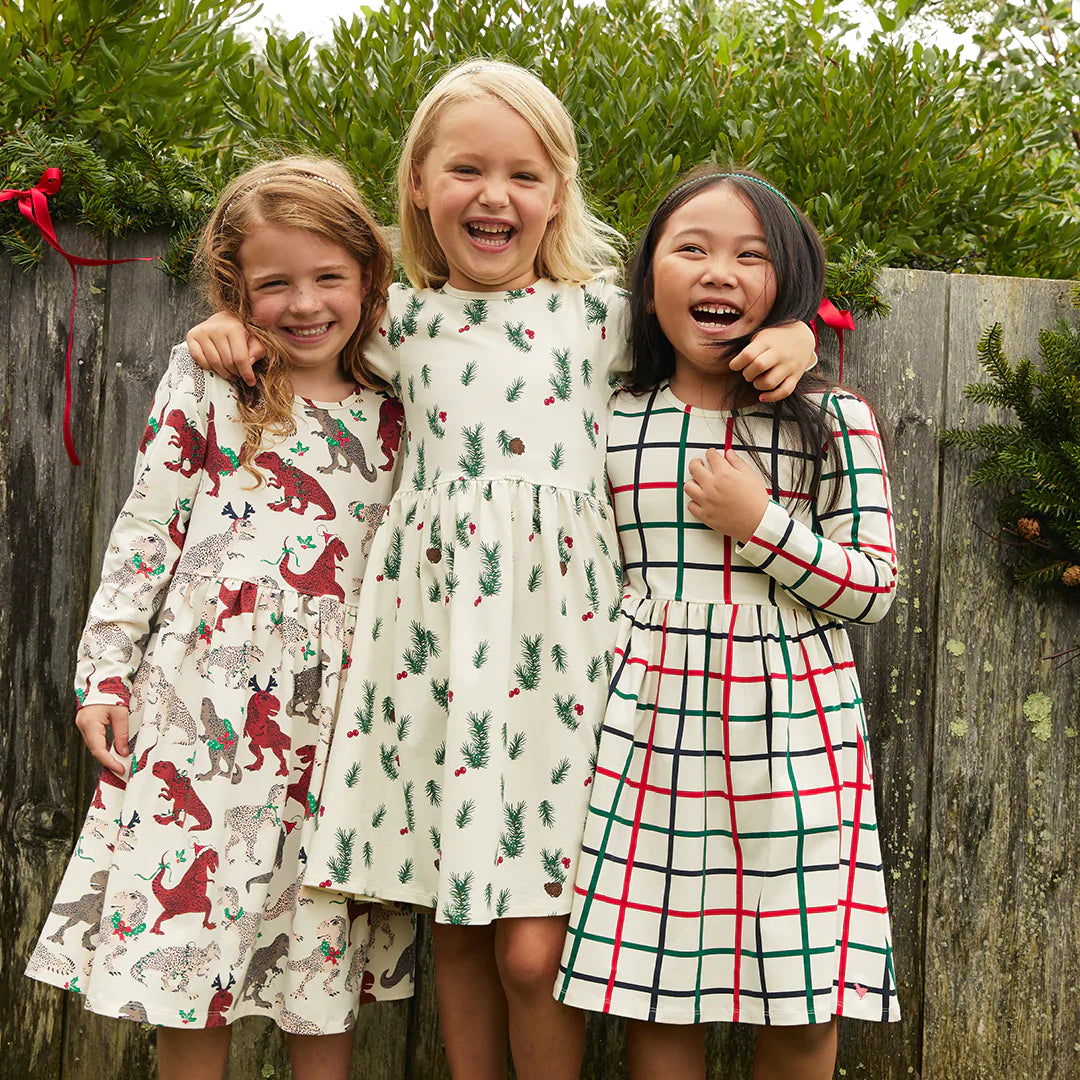 three girls wearing christmas dresses