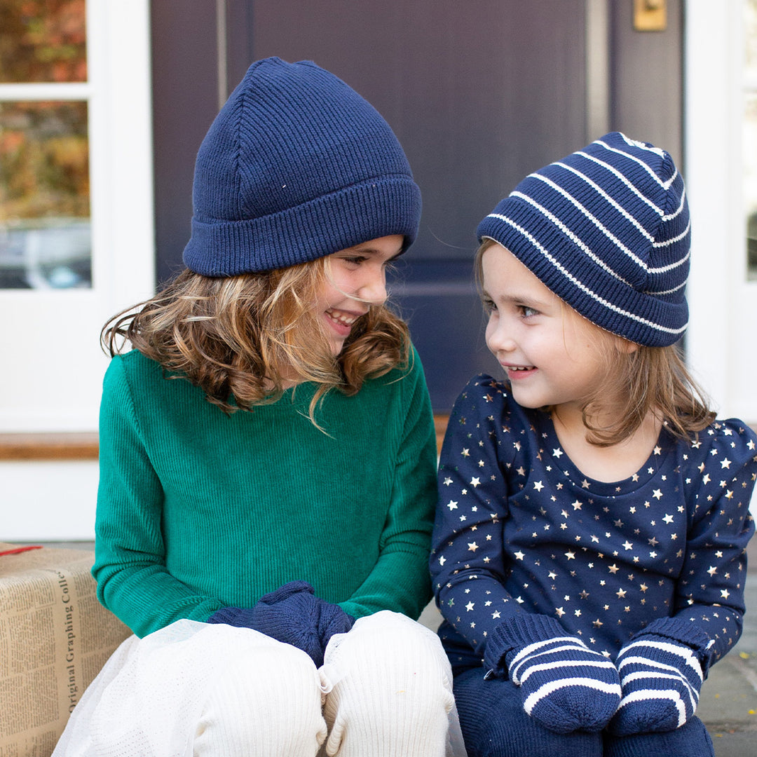 two girls wearing winter hats navy