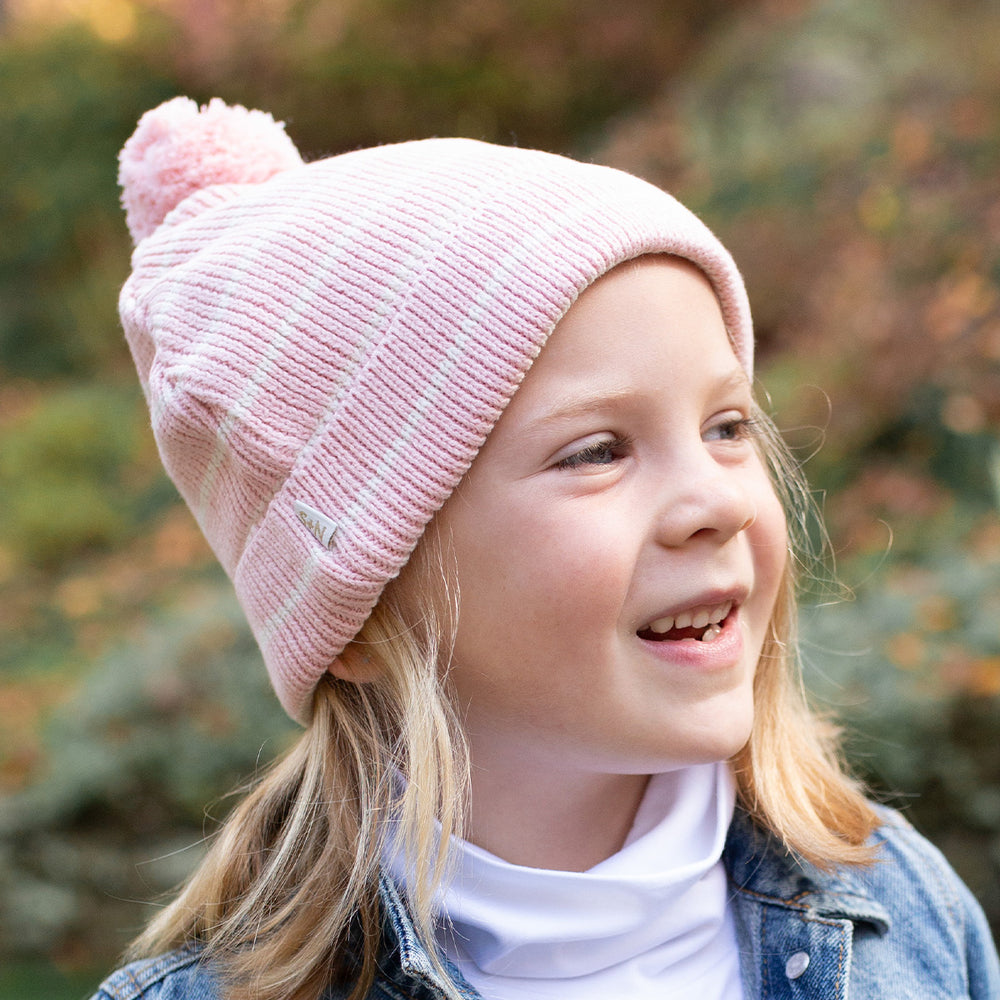 girl wearing pink stripe winter hat