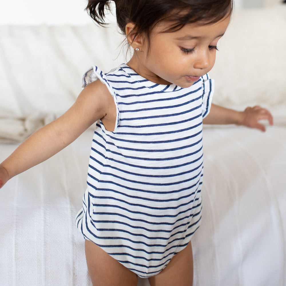 little girl wearing navy striped bubble